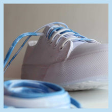 white converse low tops with blue laces