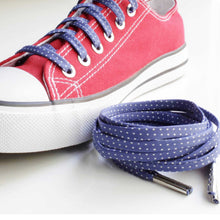 red low top converse with blue laces