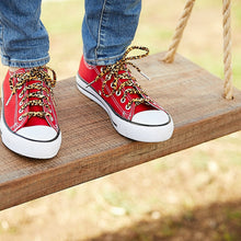 leopard print shoelaces standing on a tree swing